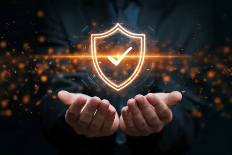 Digital security symbolized by a glowing shield with a checkmark over someone’s hands