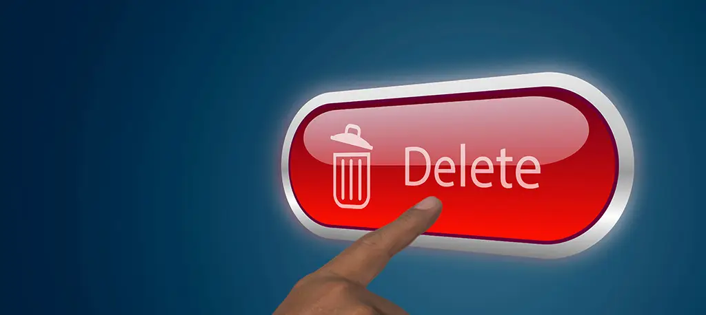 A close-up on a hand of a person pushing a delete button on a virtual screen.
