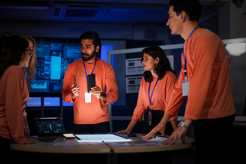 A cybersecurity team discussing solutions in the operations center