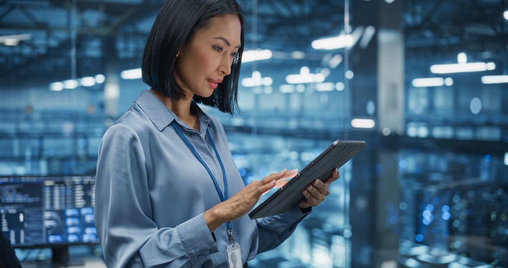 A female security specialist preparing a cybersecurity report on her tablet