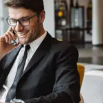 A male executive using his laptop and talking on the phone